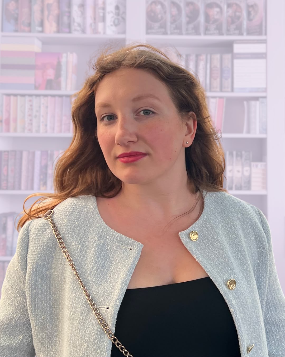 Maria in front of her bookshelf
